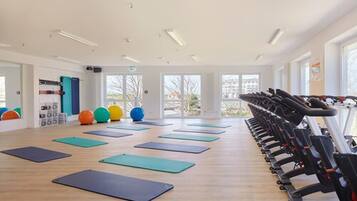 A gym with exercise mats, treadmills, and exercise balls.