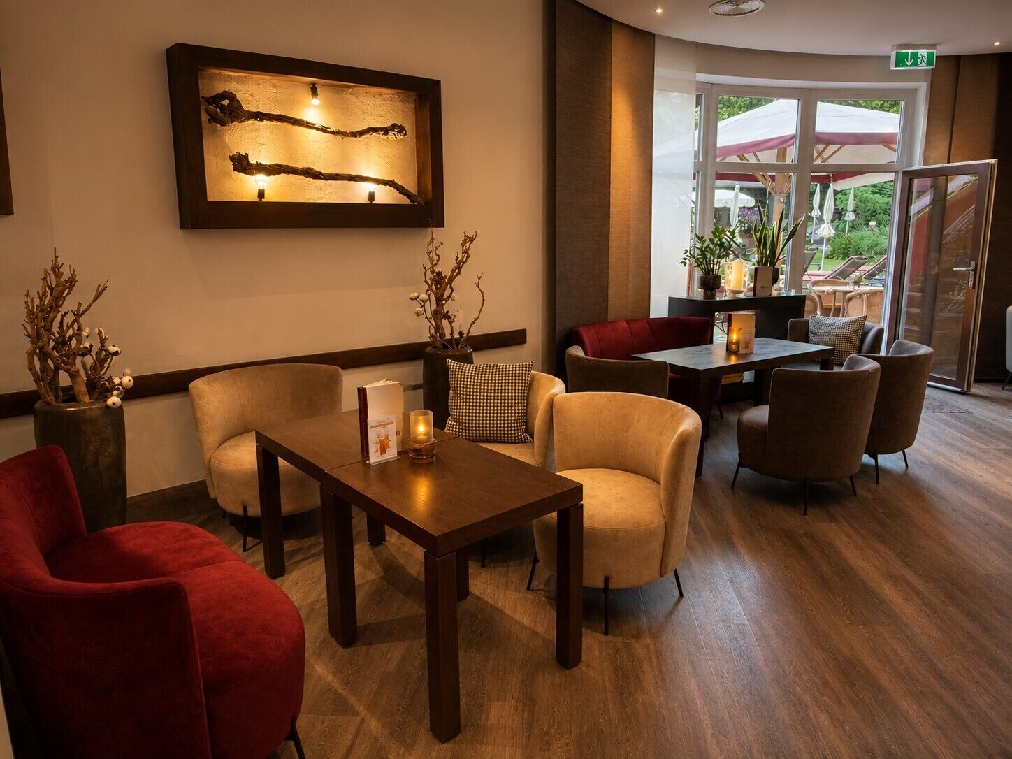 A lobby with a reception desk, seating area, and a large window with a view of the outdoors.