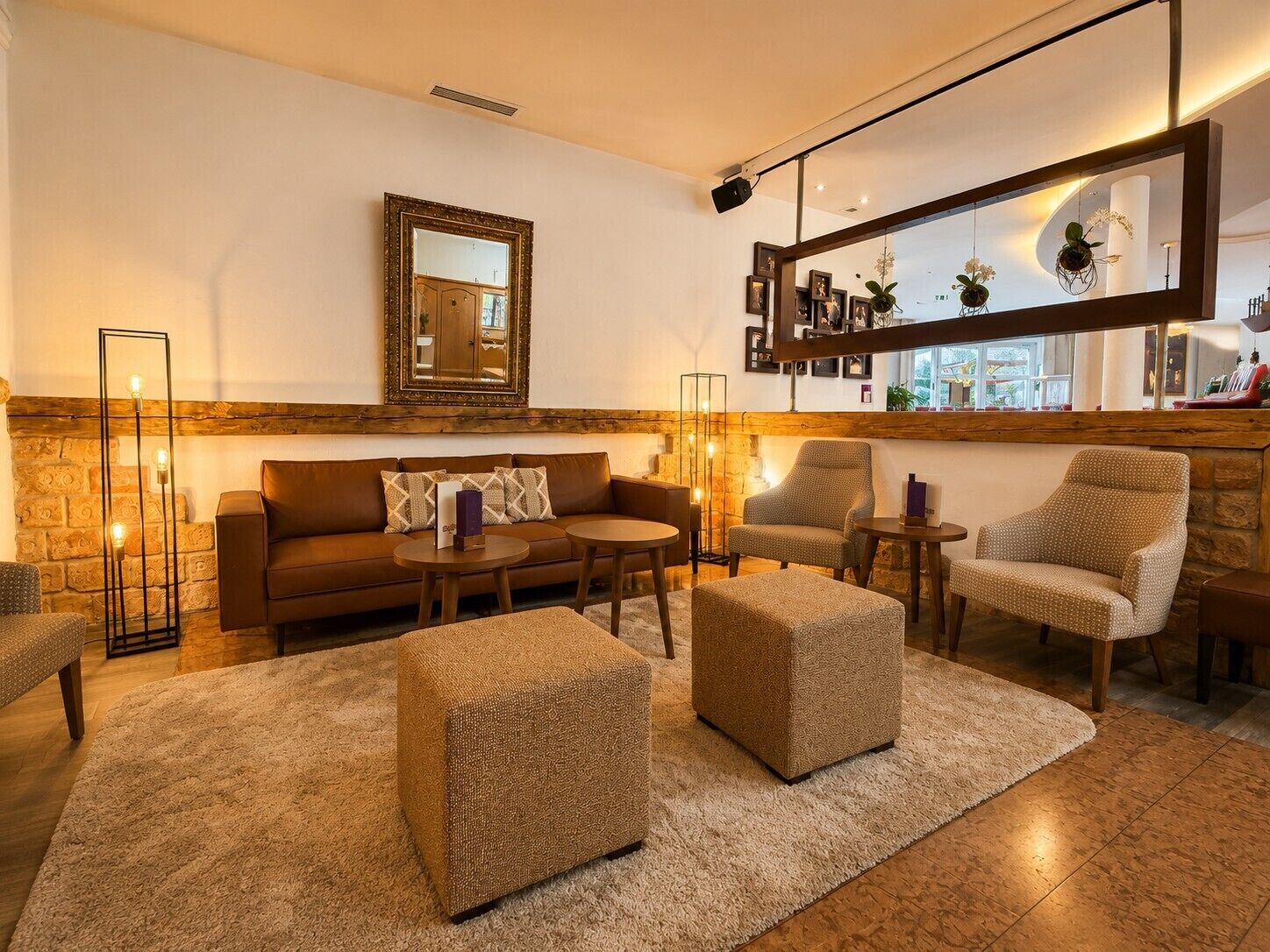 A cozy living room with a sofa, armchairs, a coffee table, and a rug.