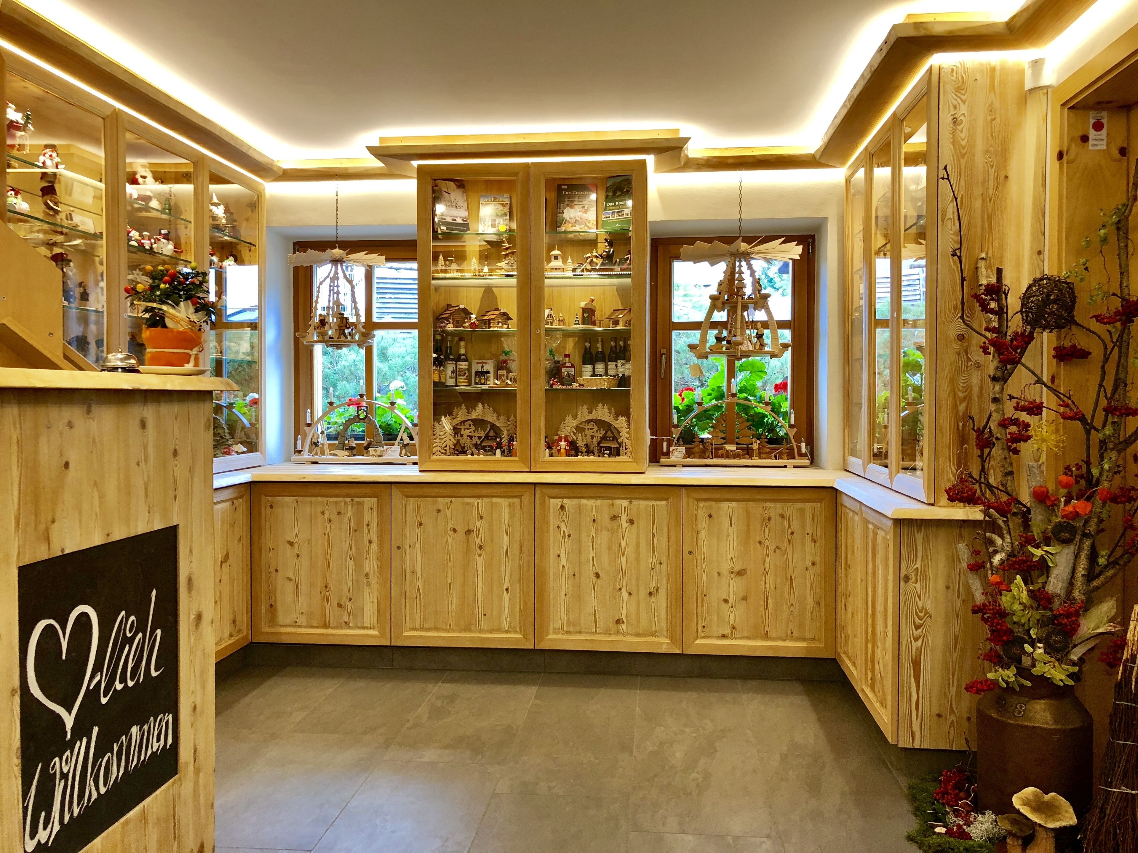A wooden interior with built-in cabinets and shelves displaying various items.