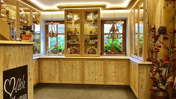 A wooden interior with built-in cabinets and shelves displaying various items.