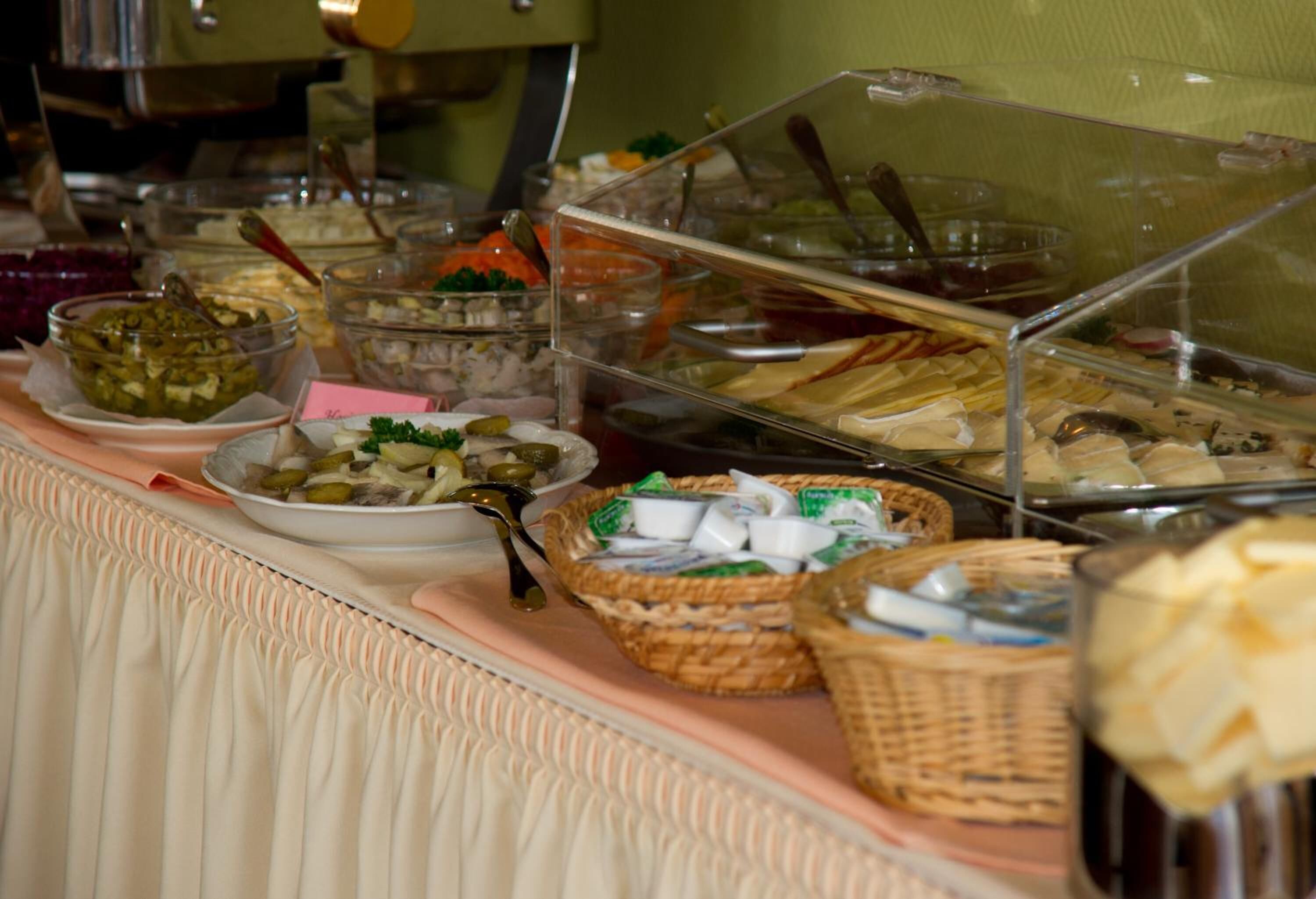 A buffet with various food items and containers.