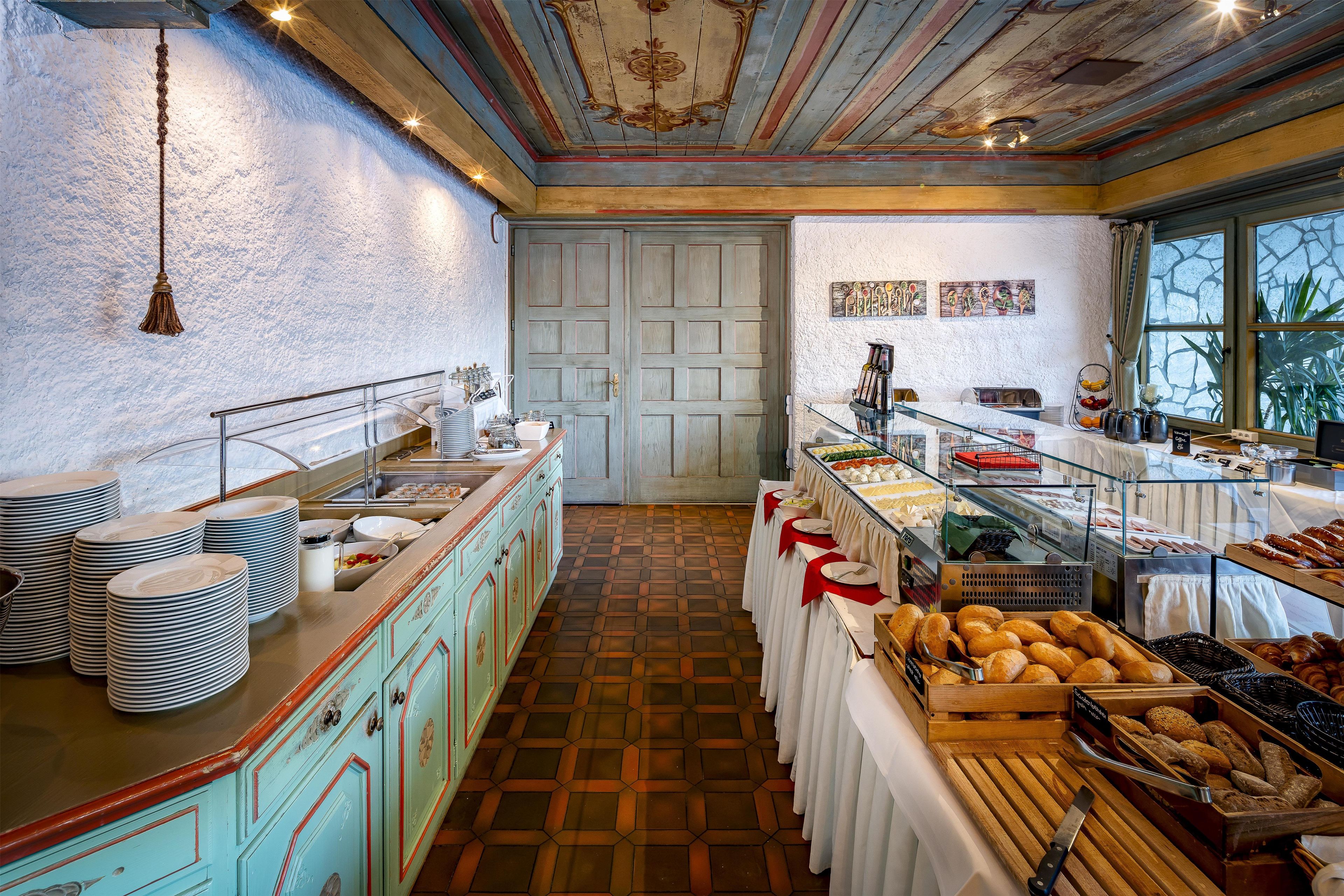 A buffet setup with various food items and a tiled floor.