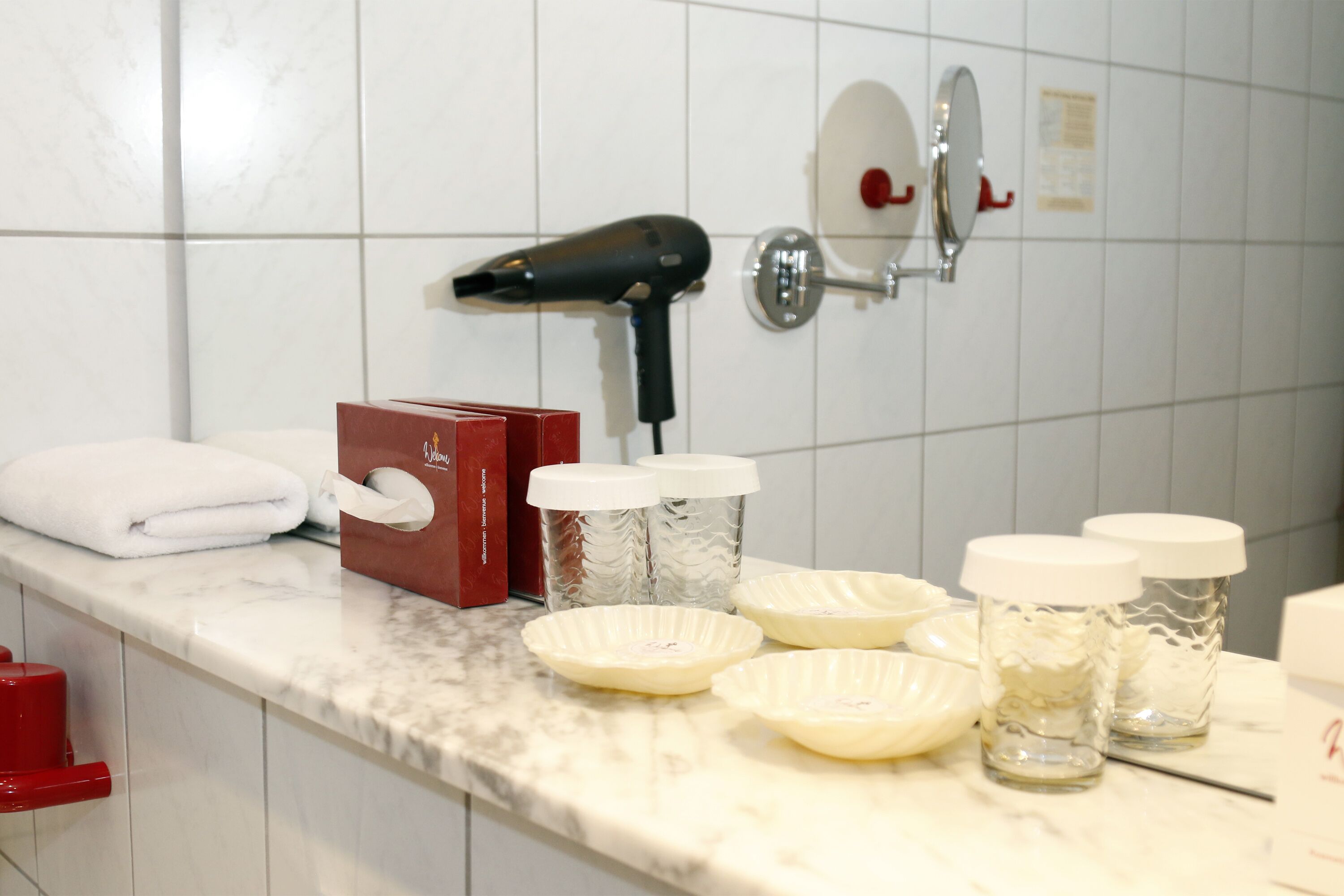 shower, hair dryer, slippers, towels