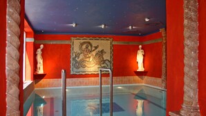 A swimming pool with a mural, statues, and a starry ceiling. - Alexa Hotel (Göhren)
