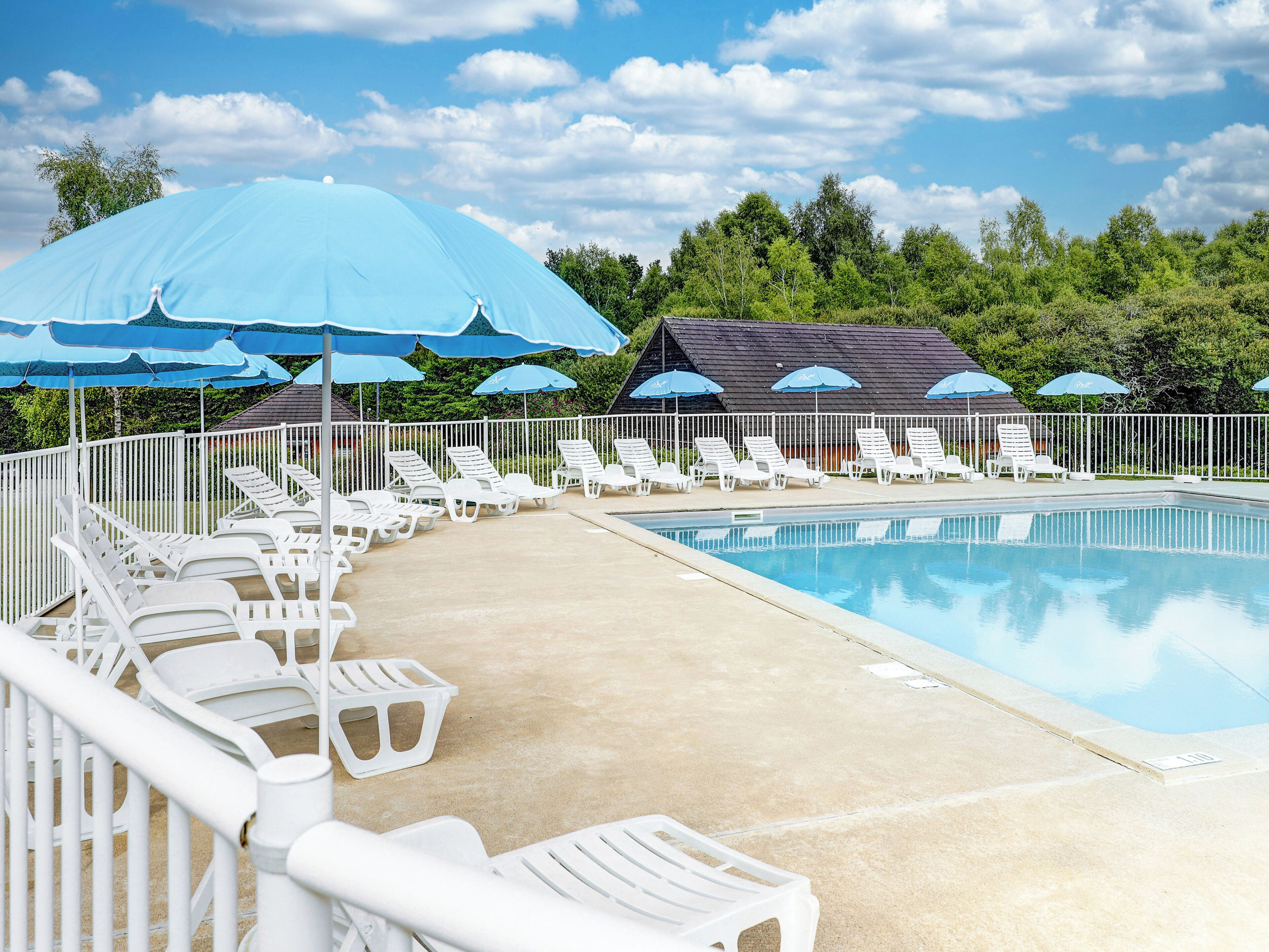 Seasonal outdoor pool, open 10:00 AM to 7:00 PM, pool loungers