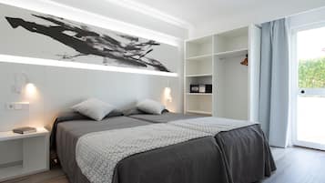 A modern bedroom with a large bed, bedside tables, a wall-mounted artwork, and a built-in shelving unit.