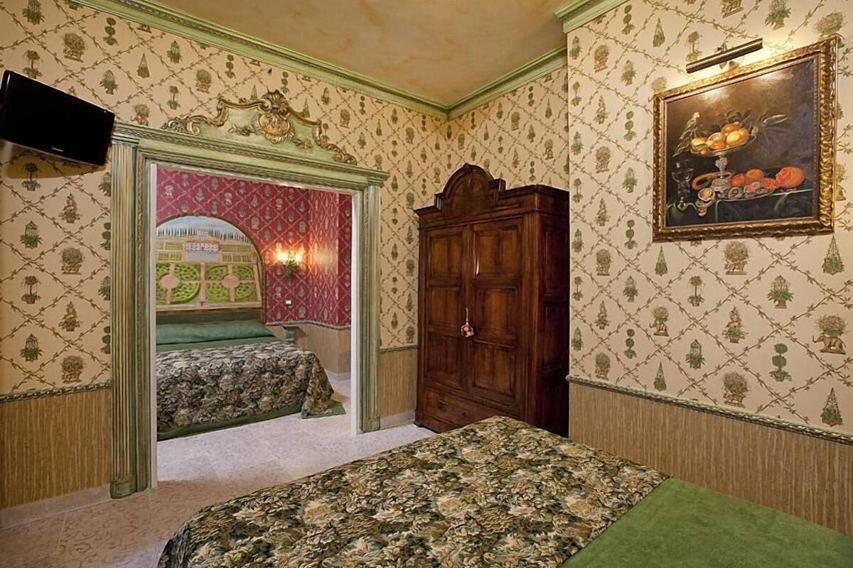 A bedroom with two beds, a wardrobe, and a painting on the wall.