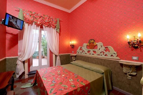 A room with a bed, a television mounted on the wall, a window with curtains, and a wall-mounted light fixture. - Residenza Horti Luculliani (Rome)