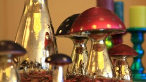 A close-up of a decorative glass object with a red top, surrounded by similar items. - Hotel Thiesmann (Muelheim an der Ruhr)