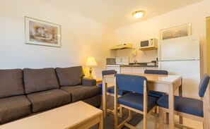 Suite, 2 Bedrooms, Kitchen | Living area | 32-inch flat-screen TV with cable channels, TV - Bon Voyage Inn (Prince George)