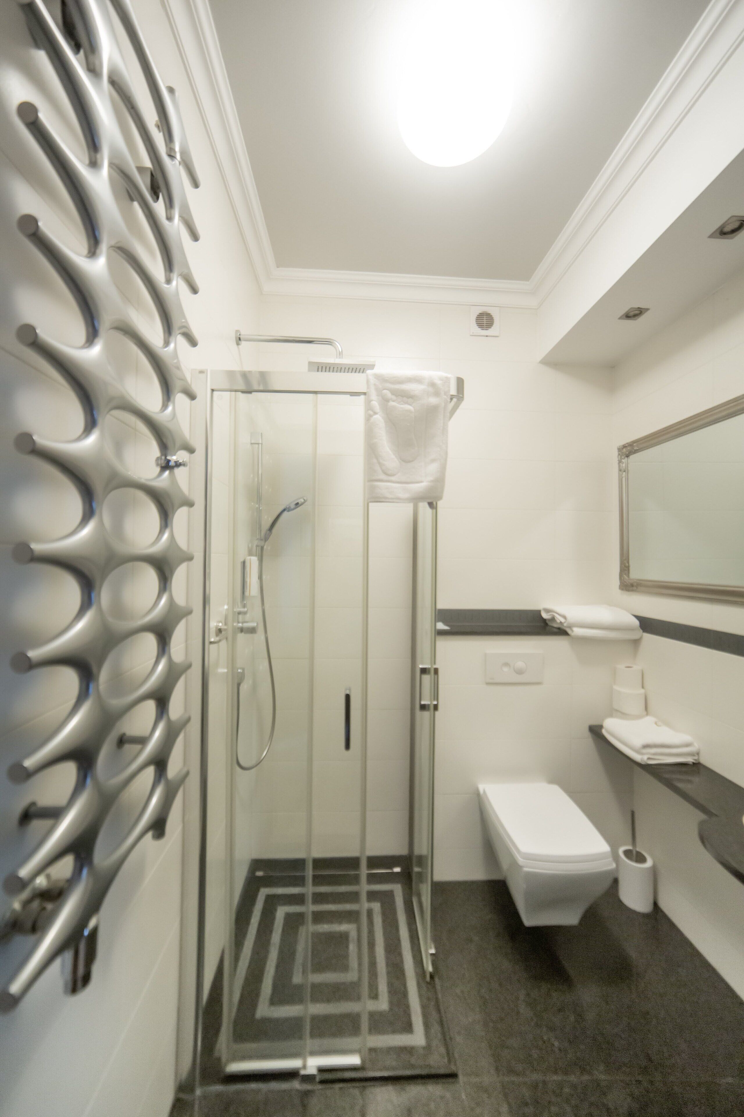 A bathroom with a shower, toilet, and sink.