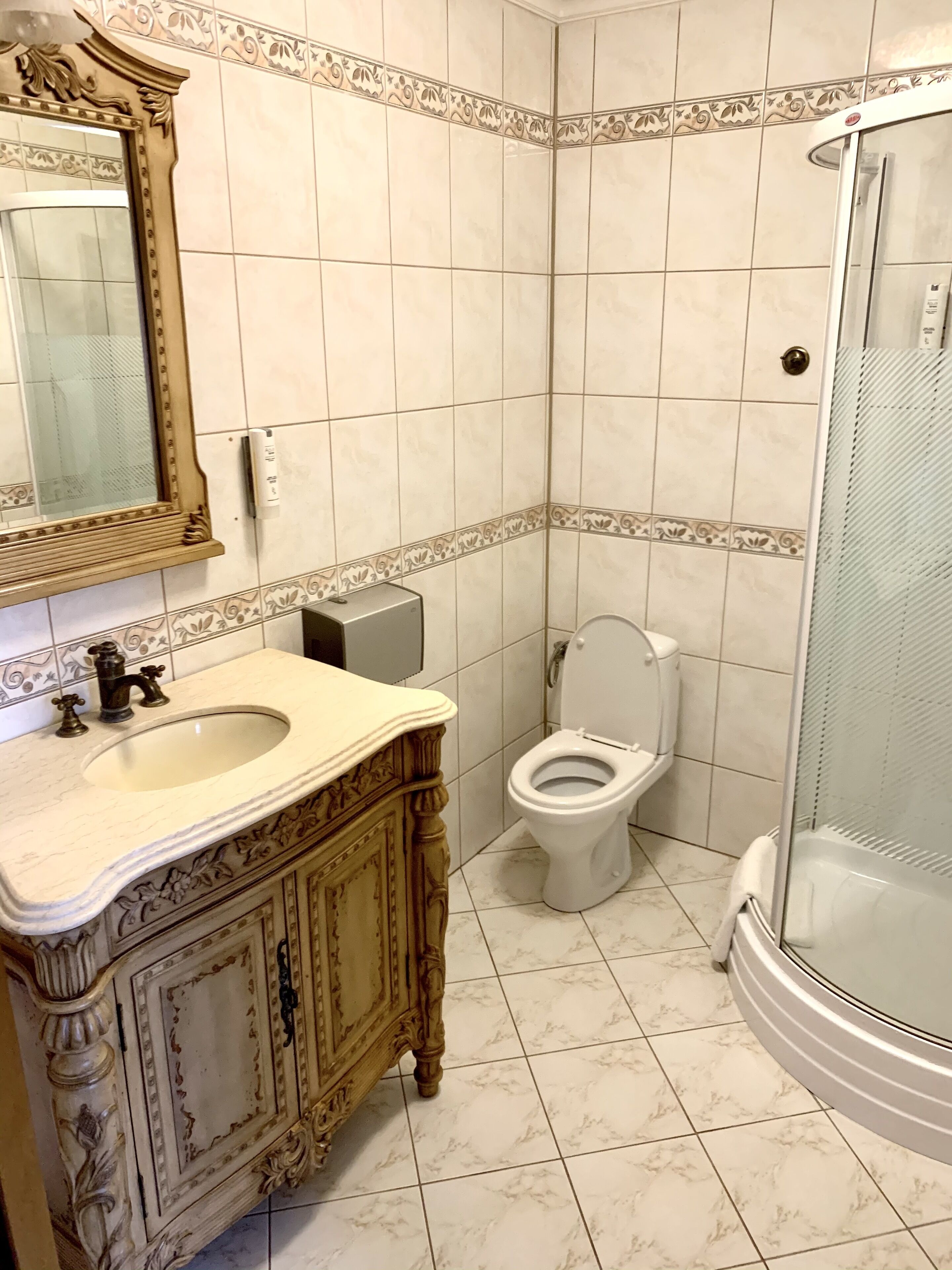 A bathroom with a sink, toilet, and shower.