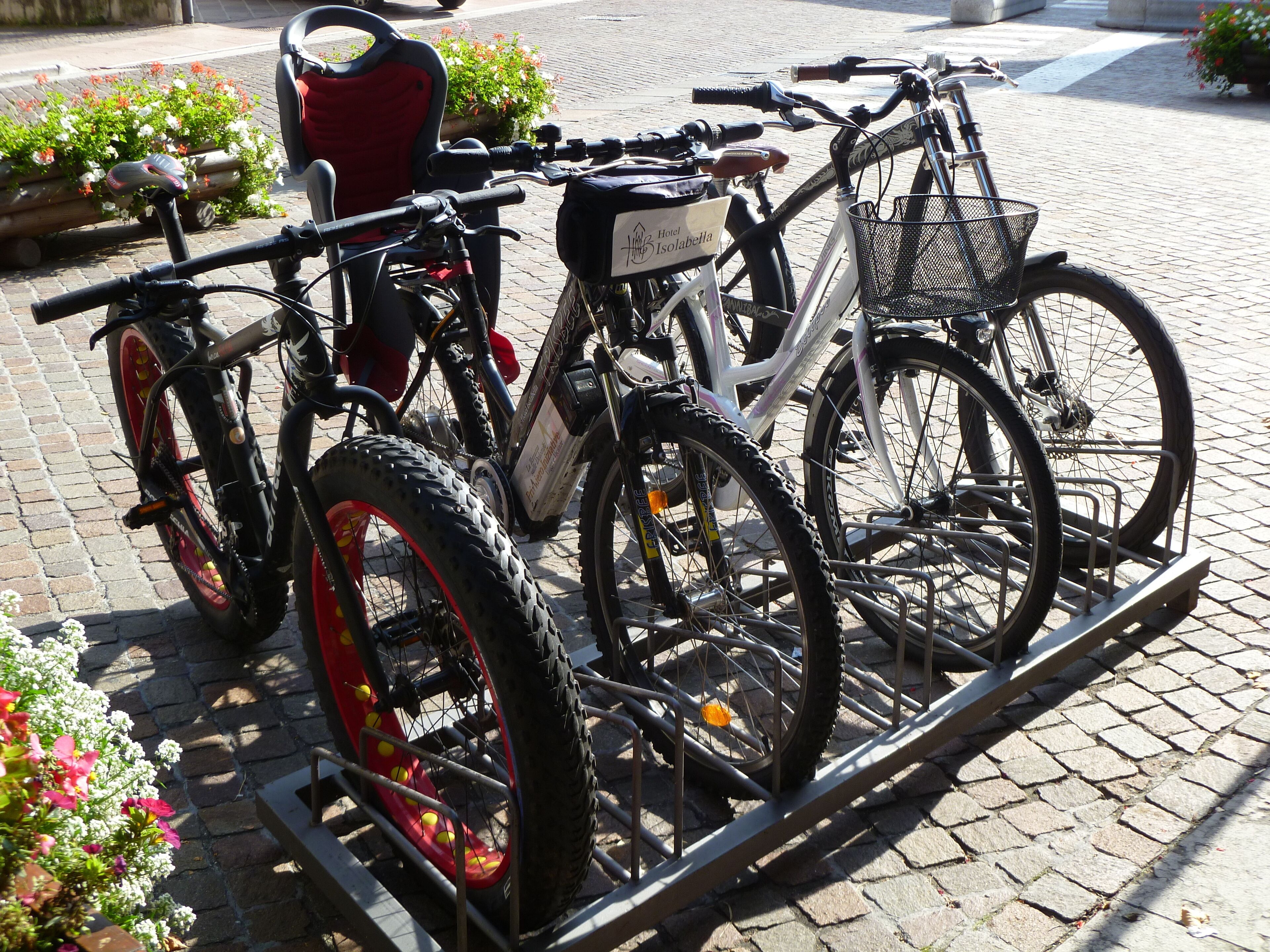 A bicycle rack with two bicycles parked on it.