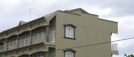 A multi-story building with balconies and windows.
