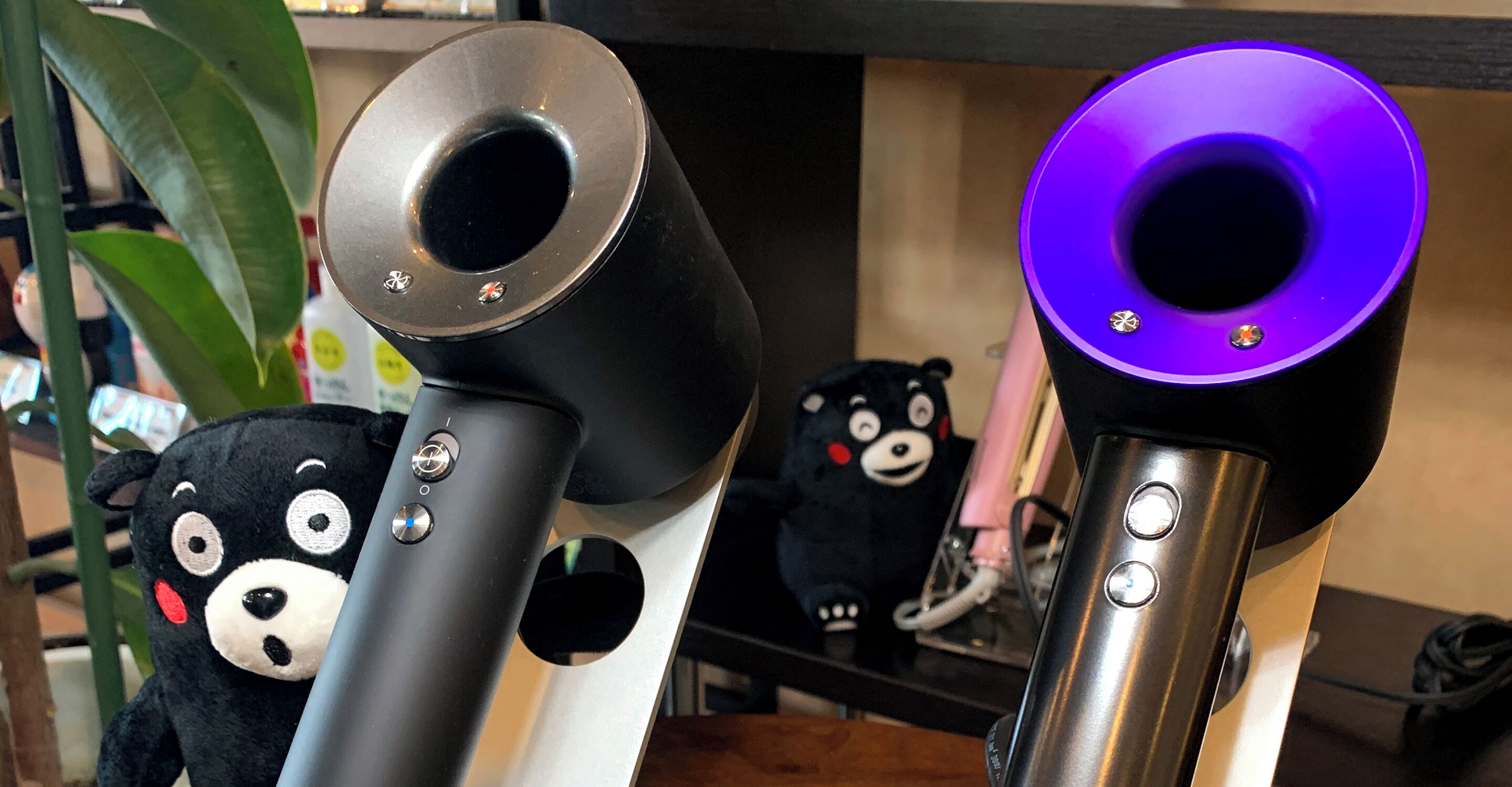 Primer plano de tres tipos diferentes de altavoces, con botones visibles y un peluche de oso de fondo.
