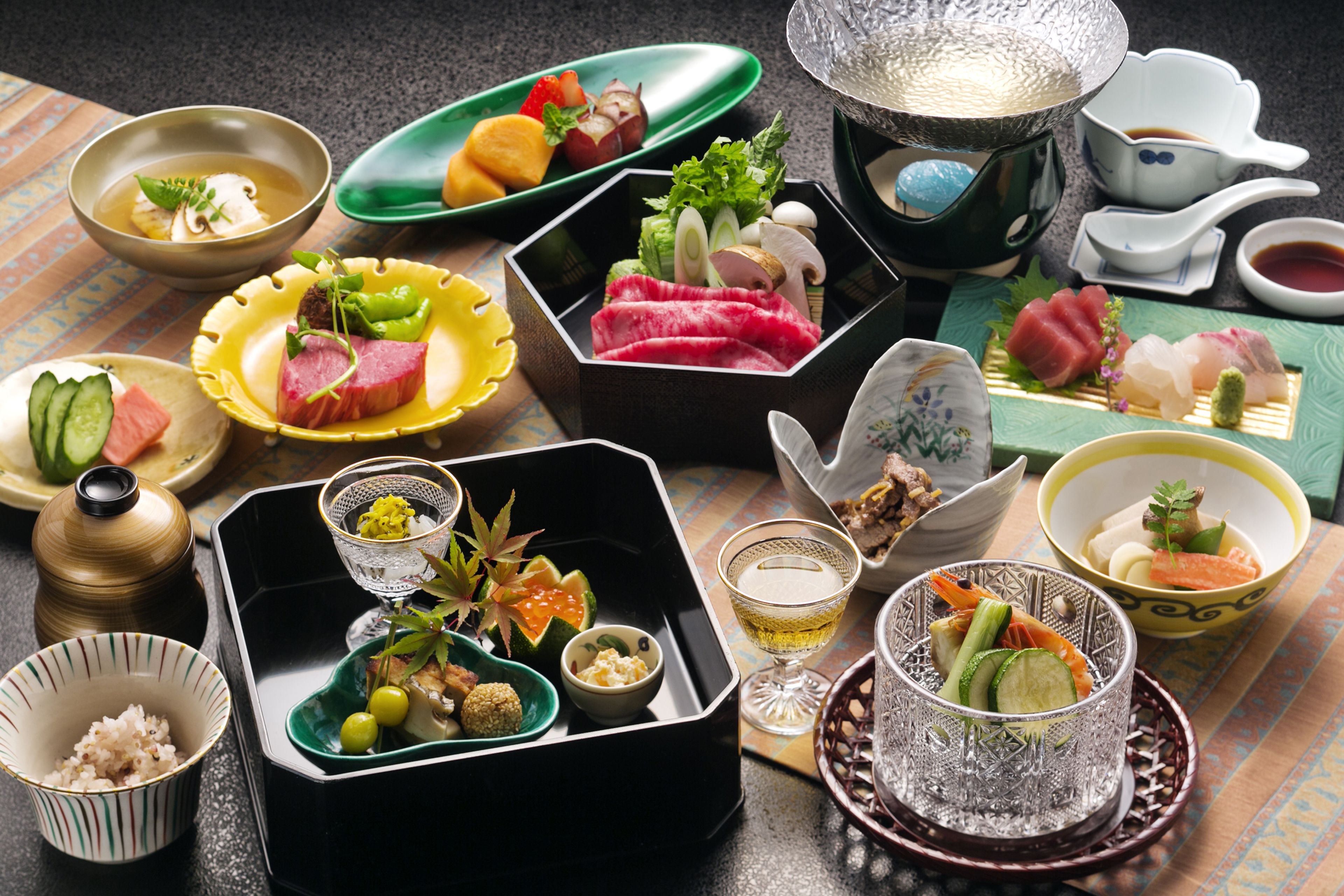 A variety of Japanese dishes and drinks arranged on a table.