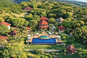 A resort with multiple buildings, a central swimming pool, and lush greenery. - The Hamsa Bali Resort (Banjar)