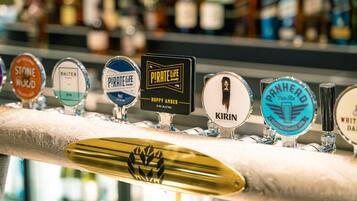 A bar with various beer taps labeled with different brands.
