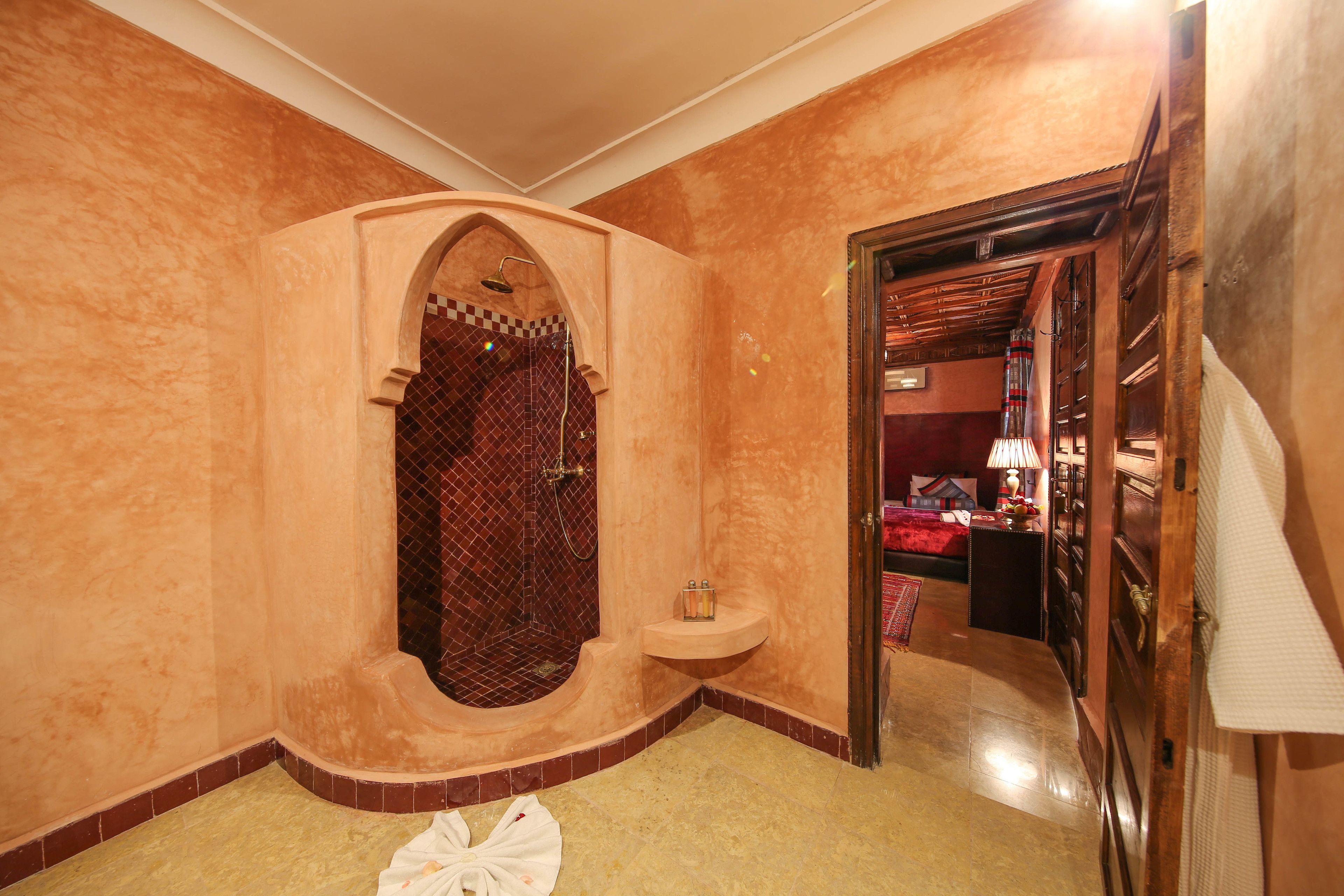 A bathroom with a large bathtub, a shower, and a sink.