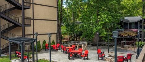 A patio area with outdoor seating and a fireplace.