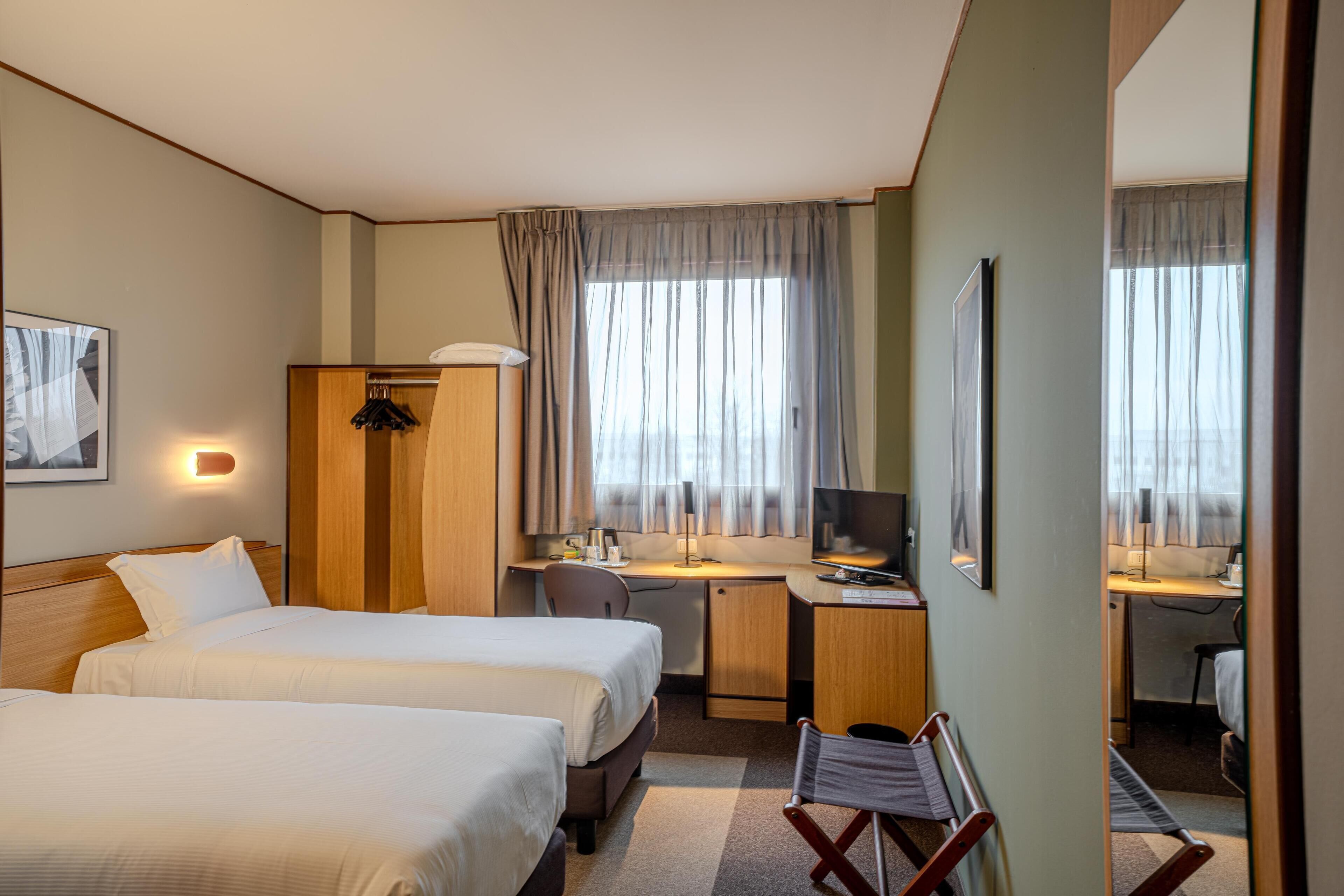 Hypo-allergenic bedding, down duvets, desk, laptop workspace