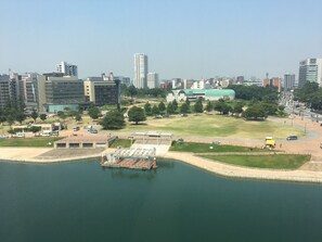 A waterfront area with a dock, buildings, and a large green field. - Hotel Crown Palais Kokura (Kitakyushu)