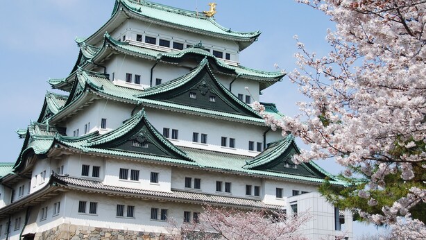 A traditional multi-tiered building with a green roof and white walls, featuring multiple windows and a stone base. - Nagoya Creston Hotel (Nagoya)