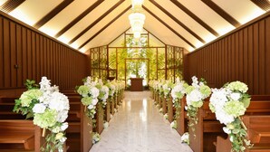 A church interior with wooden pews, a marble floor, and floral arrangements. - Nagoya Creston Hotel (Nagoya)