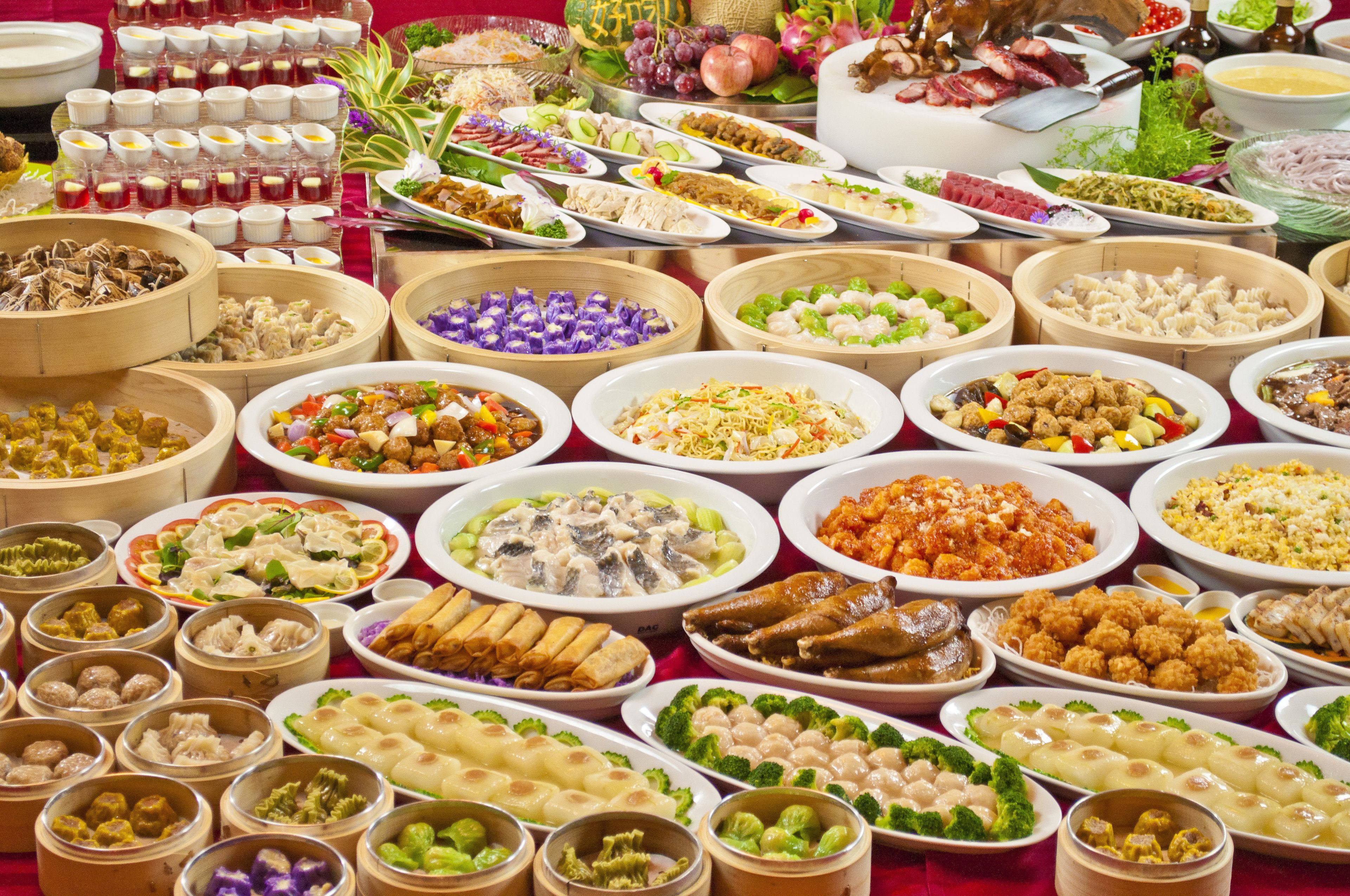 A variety of dishes arranged on a table, likely for a buffet.