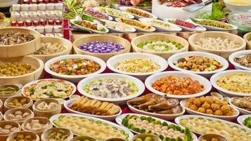 A variety of dishes arranged on a table, likely for a buffet.