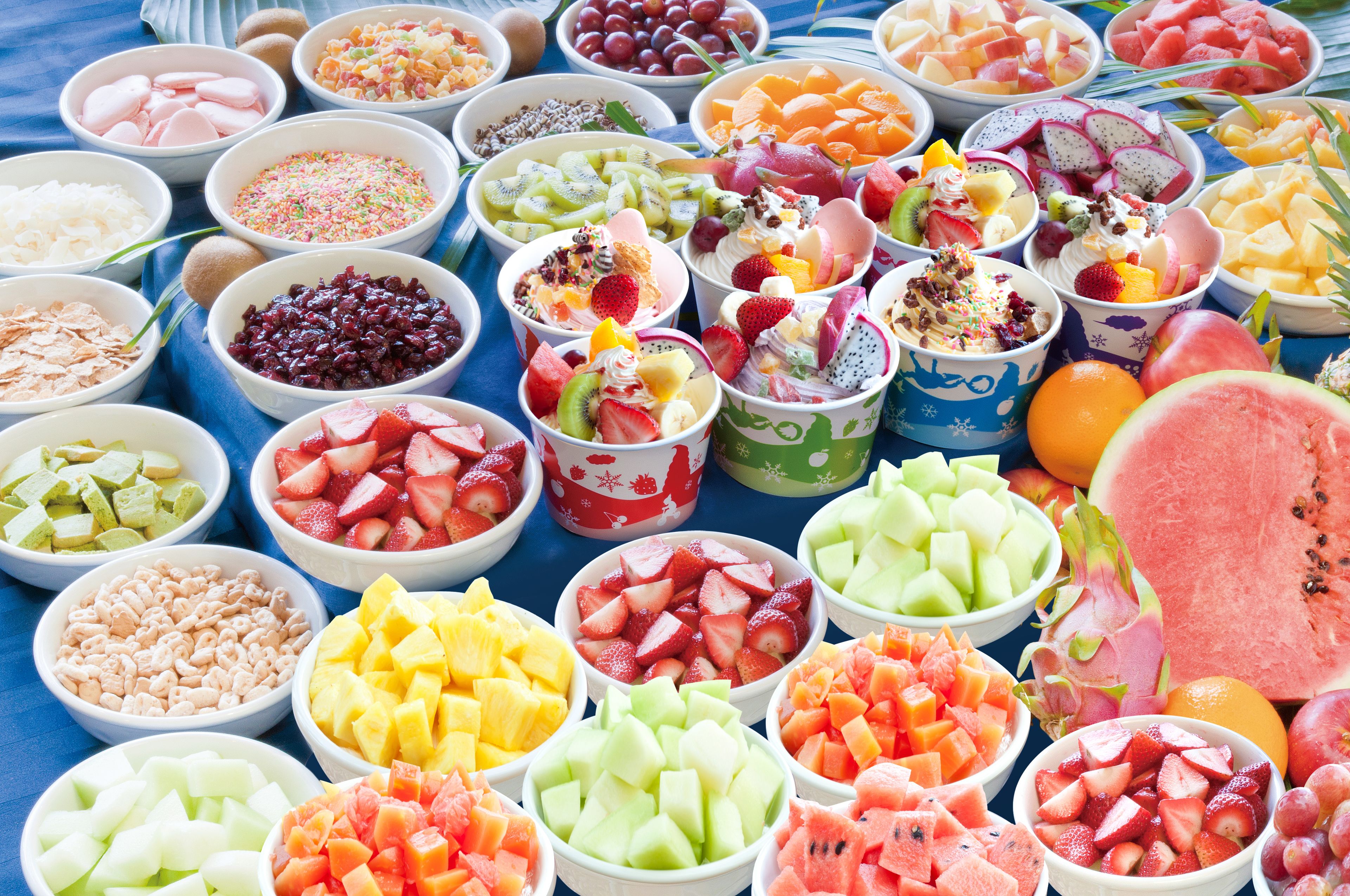 A variety of fruit bowls arranged on a table.