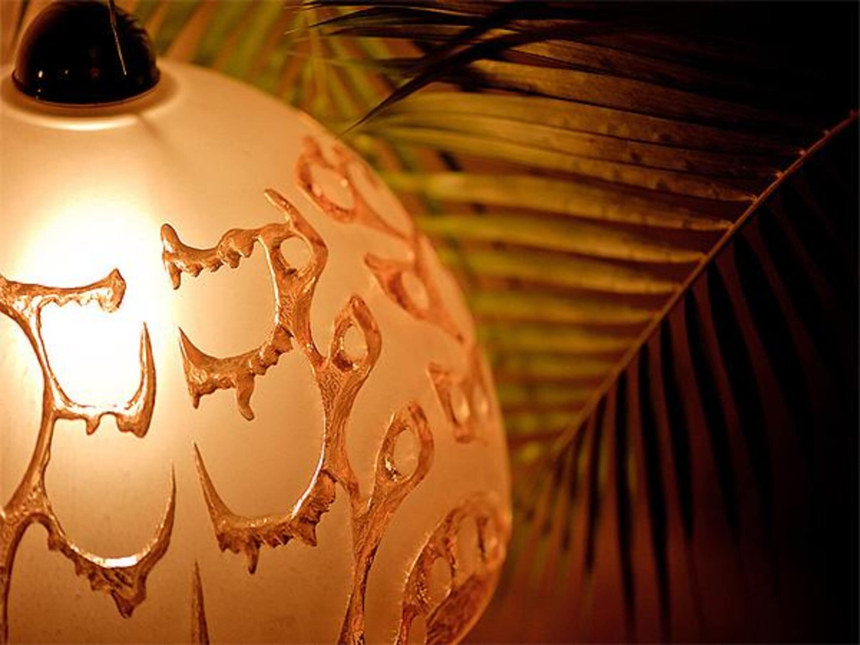 A close-up of a decorative lamp with intricate designs.