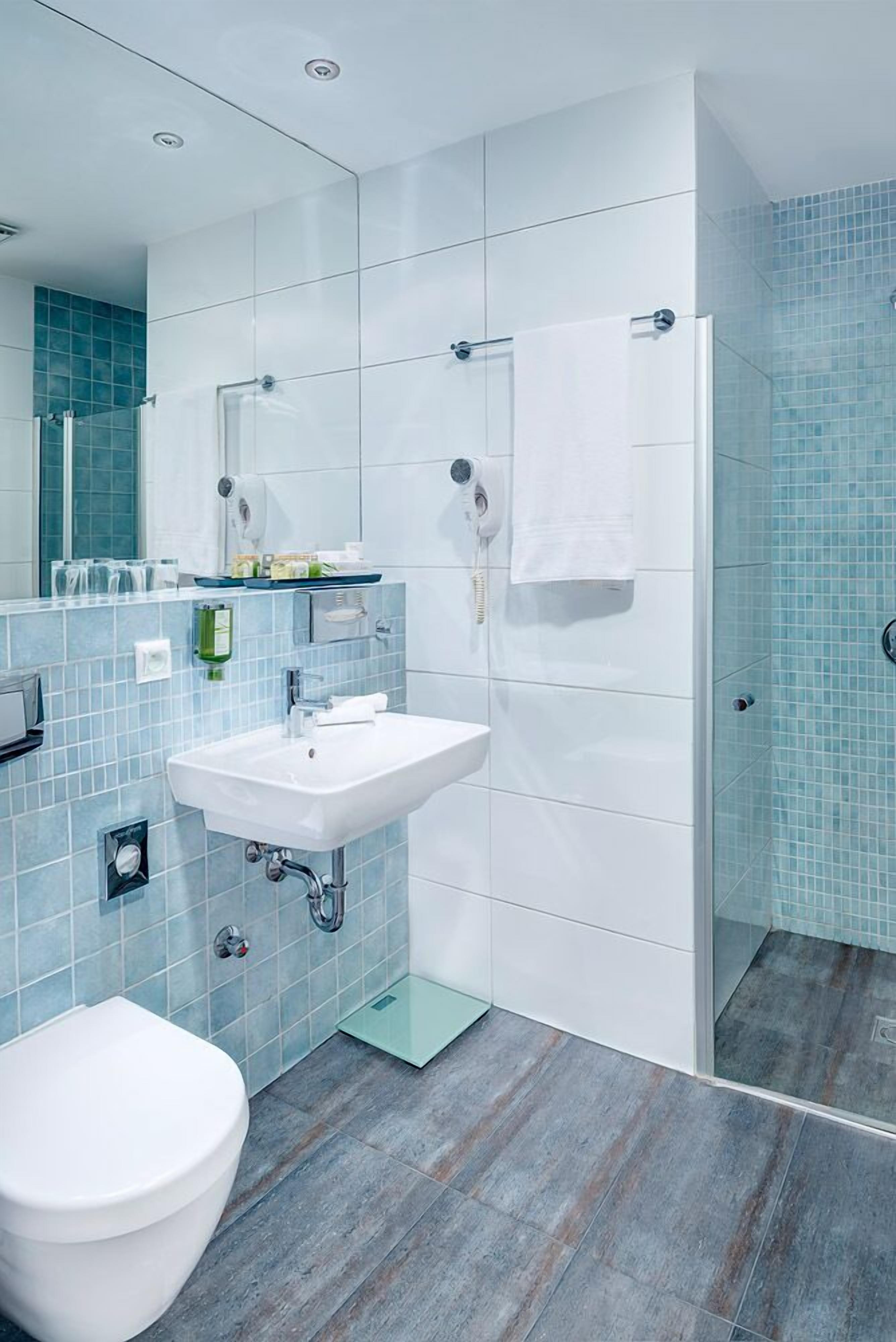 bathtub, hair dryer, bidet, towels