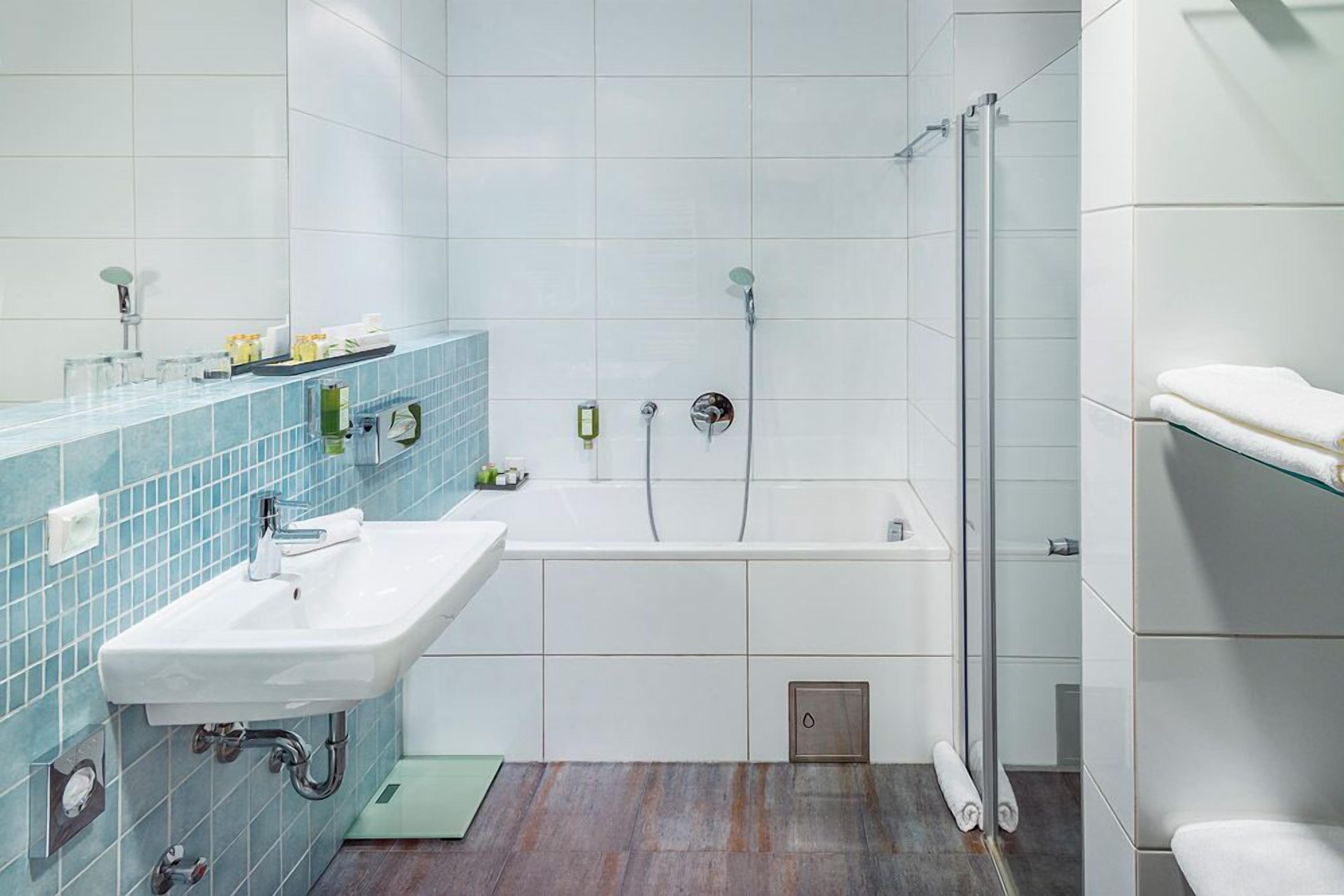 superior double room | bathroom | bathtub, hair dryer, bidet, towels