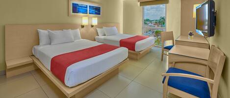 A hotel room with two beds, a desk, a chair, a TV, and a window with a view.