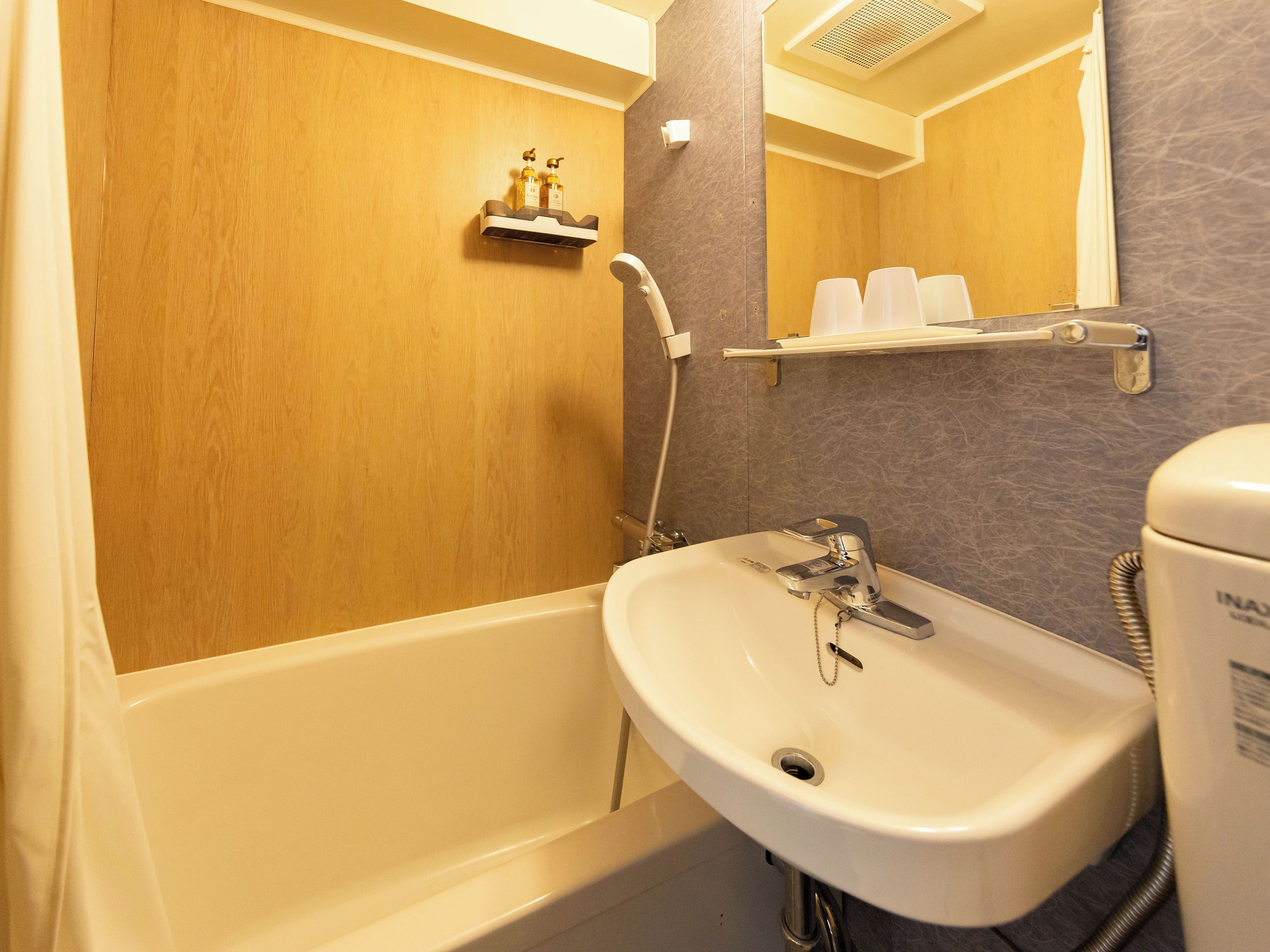 A bathroom with a bathtub, a sink, and a toilet.