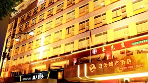 A multi-story hotel with illuminated signage, a lion statue in front, and a clear view of the entrance. - Baiyun City Hotel (Guangzhou)