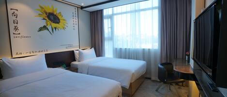 A hotel room with two beds, a TV, and a large window with curtains.