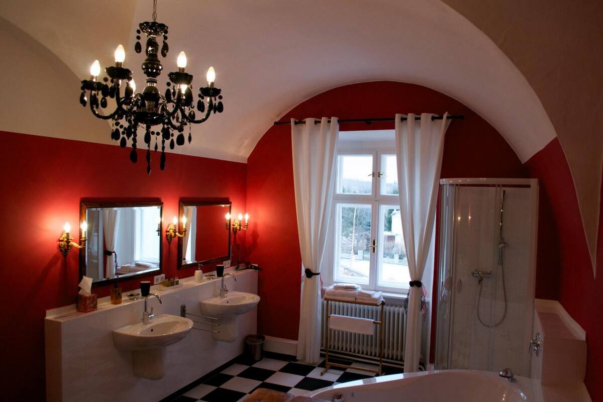 luxury suite | bathroom | rainfall showerhead, designer toiletries, hair dryer, slippers