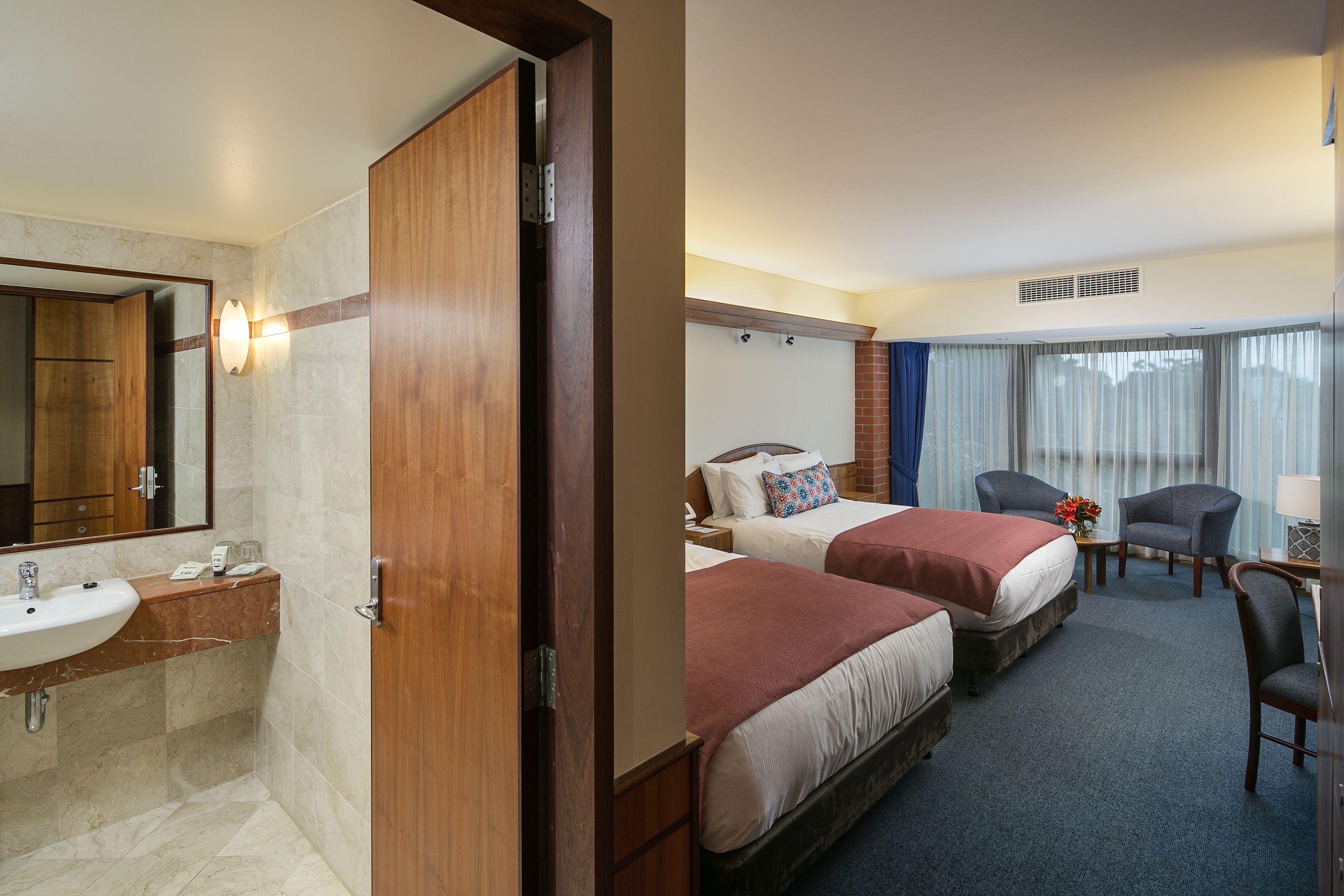 deluxe twin queen room | premium bedding, pillow-top beds, desk, blackout curtains
