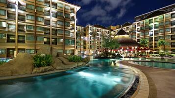 Een buitenzwembad, parasols voor strand/zwembad