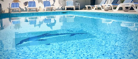 Seasonal outdoor pool, open 9:30 AM to 7:00 PM, pool loungers