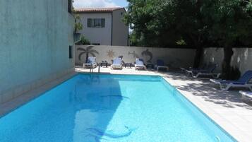 Seasonal outdoor pool, open 9:30 AM to 7:00 PM, pool loungers