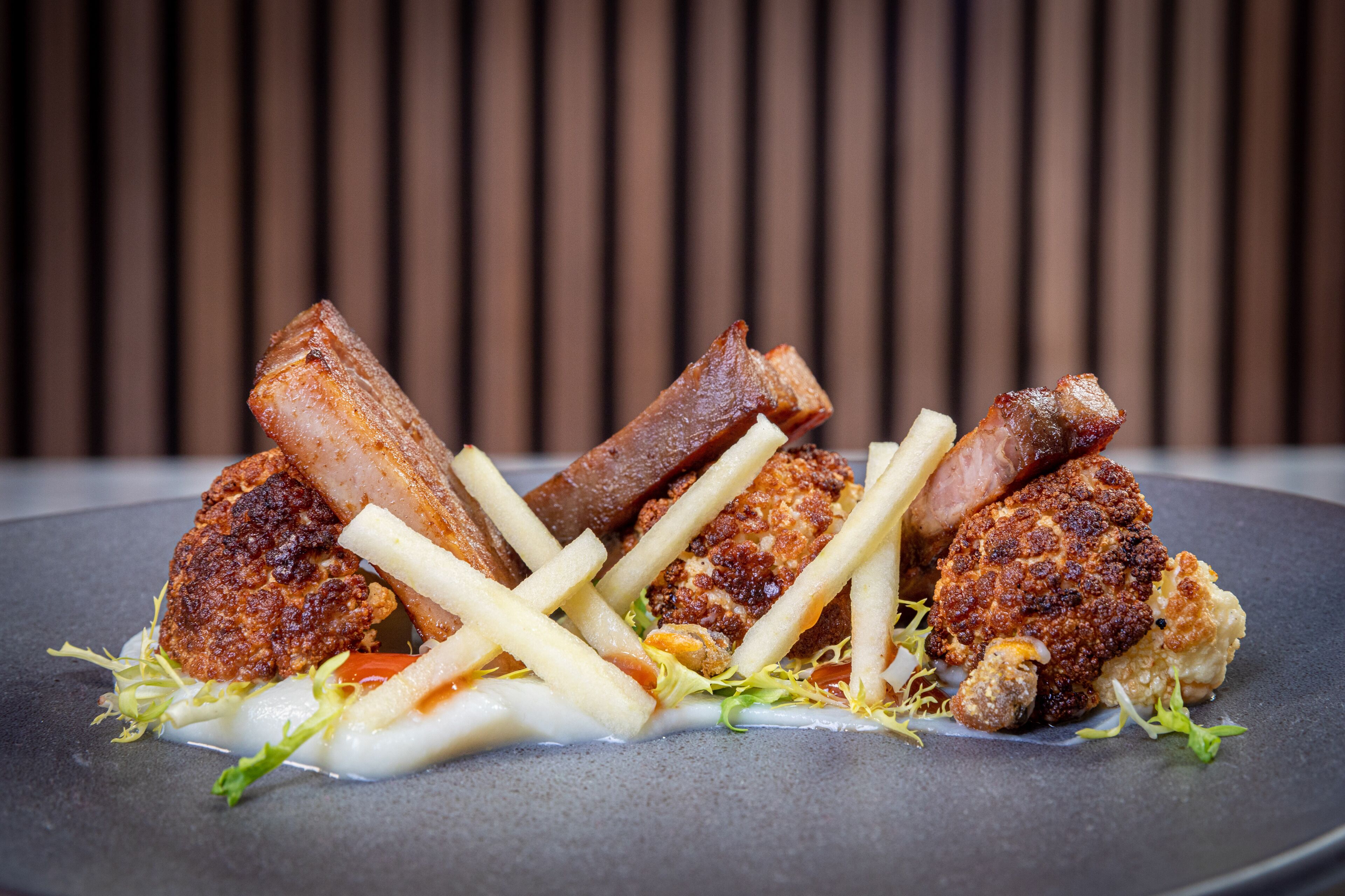 A plate of food with various meats and fries.