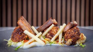 A plate of food with various meats and fries.