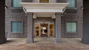 A building entrance with a covered walkway, large windows, and a tiled floor. - Holiday Inn Express & Suites Morrilton by IHG (Morrilton)
