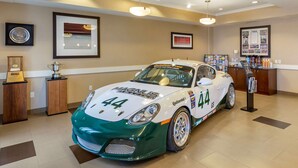 A race car in a showroom with framed awards on the walls. - Comfort Inn & Suites Tooele - Salt Lake City (Tooele)