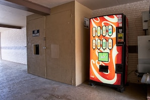 A vending machine with a Coca-Cola and Sprite logo, located next to a door labeled "ICE MACHINE". - Quality Inn (Garysburg)