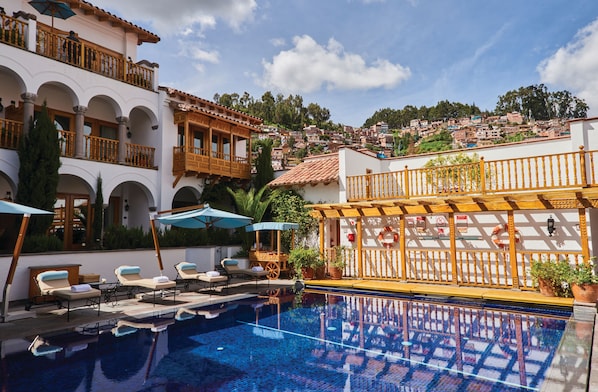 Outdoor pool, open 10:00 AM to 5:00 PM, pool umbrellas, pool loungers